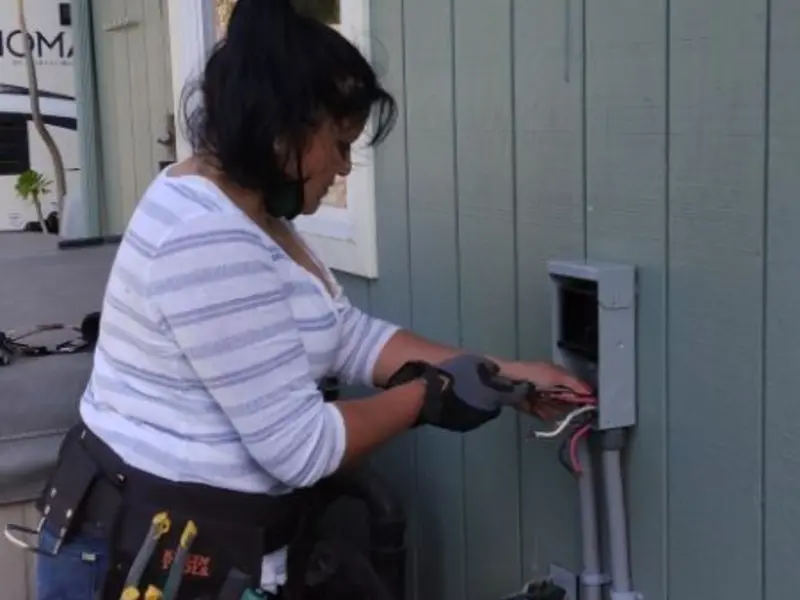 Licensed electrician wiring an exterior subpanel in Pine Castle